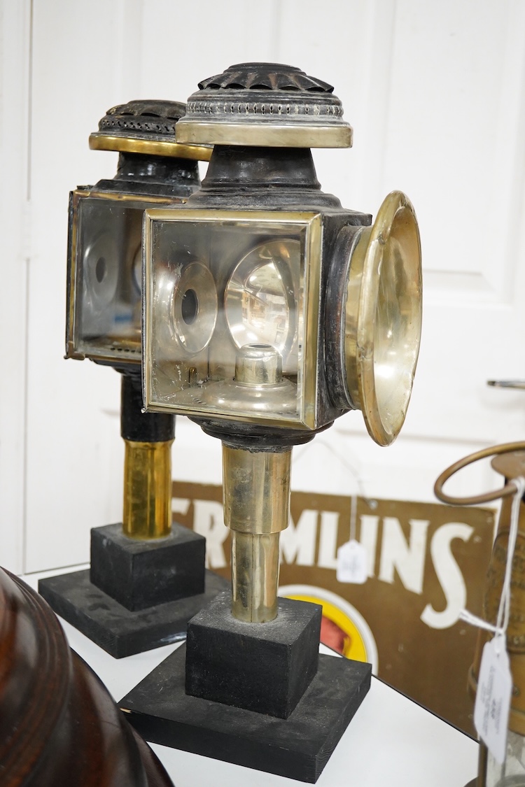 Two 19th century brass and painted steel carriage lamps, one by Raydyot with sprung ‘self adjusting’ candle holders, now mounted on modern painted pine bases for display purposes